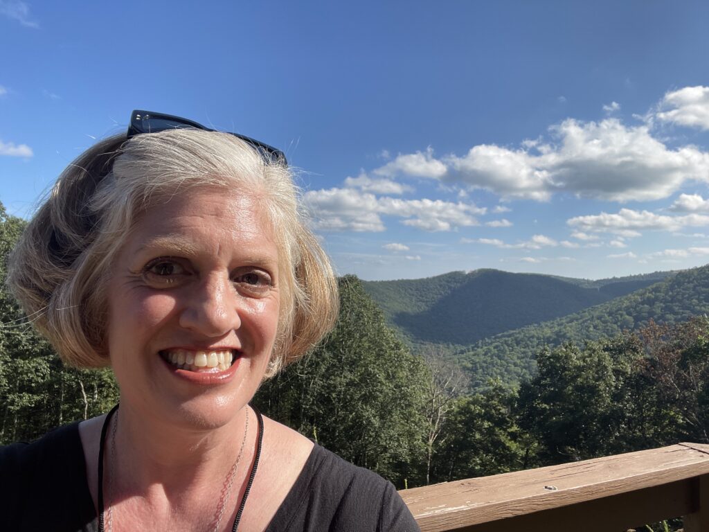 Emily in front of view of mountains