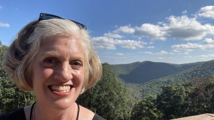 Emily in front of view of mountains