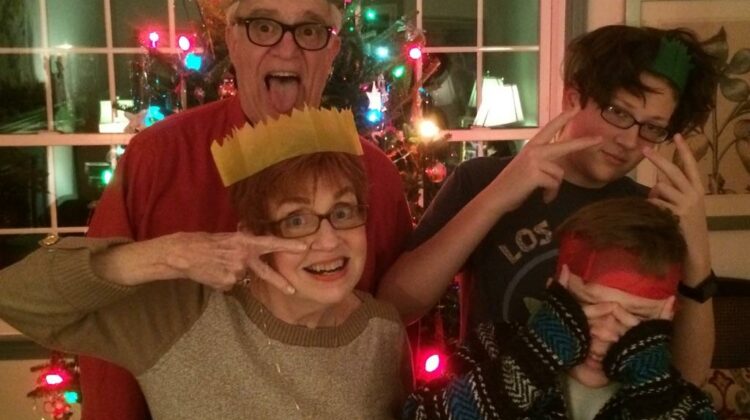 Family in front of Christmas tree